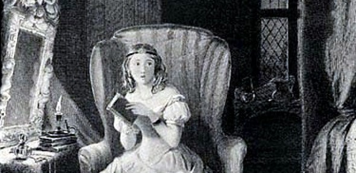 Lady sitting in a chair with a book